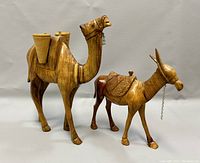 Front view of both camel and donkey figurines showing front details and size comparison.