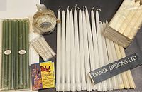 Photo showing all candles including the pearlized hobnail ball candle with gold bow, IKEA White Hushall chandelier candles, white tapered candles, green slender candles, and Dansk Designs Ltd boxed tapered candles.