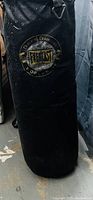 Photo of a large black Everlast punching bag standing upright with the logo prominently displayed.