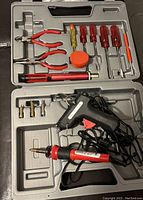 Tool kit including soldering iron, glue gun, pliers, screwdrivers, utility knife in a gray case