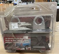 Front view of plastic packaging containing two chrome plated stake pocket anchors with Erickson branding and usage illustration.