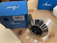 Photo of Alsons shower head with packaging showing brand and flow rate 1.85 GPM