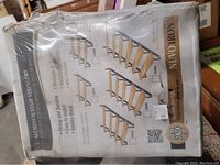 Photo showing packaging for aluminum stair stringers featuring various step configurations and product details including strong and durable aluminum with black satin finish.