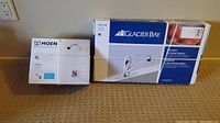 Two new in box faucets: Glacier Bay pullout kitchen faucet and Moen Adler L82691 shower faucet