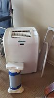 Hisense portable air conditioner unit with vent hose and frame accessory placed on the floor.
