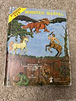 Front cover of the 1978 Advanced Dungeons and Dragons Monster Manual showing detailed fantasy artwork of various monsters and creatures.
