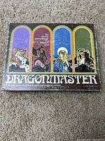 Top view of Dragon Master boxed game showing title and fantasy character artwork on lid.