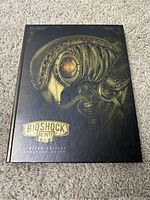 Front cover of Bioshock Infinite Limited Edition Strategy Guide showing mechanical bird artwork with gold embossed title