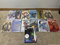 Photo of assorted comic books including Magic the Gathering, Carnage, Spawn, Marvel Spiderman and others on the floor