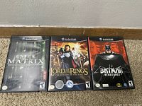 Front covers of three Nintendo GameCube game cases: Enter the Matrix, Lord of the Rings, Batman Vengeance