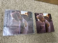 Justin Bieber Justice CD in original sealed plastic packaging next to the signed photo showing the same artwork and autograph.