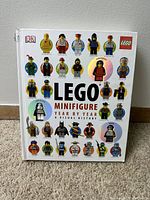 Front cover of the LEGO Minifigure Year by Year book showing multiple LEGO minifigures and the title.