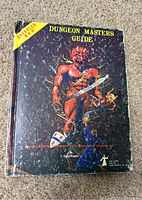 Front cover of the Dungeon Masters Guide showing original 1979 Advanced Dungeons & Dragons artwork with demon and wizard figure.