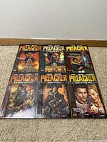 Six Preacher comic book trade paperbacks laid out front cover up showing cover artwork and titles