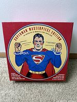 Closed red box featuring classic 1938 Superman image breaking chains, text 'Superman Masterpiece Edition'