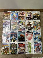Photo showing 20 Nintendo Wii game cases laid on floor in rows of five showing front cover artwork.