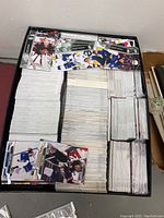 View of the box filled with neatly stacked and organized hockey cards packed tightly inside a 2-layer black box