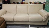 Front view of cream leather sofa bed