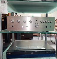 Frontal view of Sansui AU-2200 stereo amplifier on top shelf and Sony BDP-S300 CD Blu-ray player below