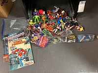 Wide view of all toys included showing figures, kite, and sticker books.