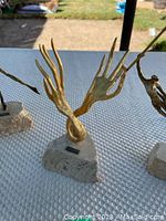 Close-up of abstract antler bronze sculpture on stone base
