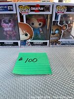 Photo showing three boxed Funko POP! figures including Freddy, Chucky, and Twisted Freddy with lot number