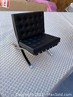 Miniature Barcelona-style chair, black tufted cushions, chrome X-frame