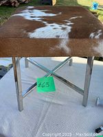 Side angle view of stool legs showing chrome finish and crossbar support.