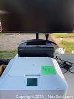 Full view of Canon MG7120 white printer, Dell black printer stacked, LG monitor in background