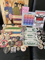 Full shot of calendar page and assorted Beatles items spread over black background