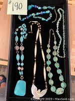 Full overview of all five necklaces in the lot.