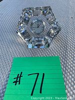 Front angled view of the crystal clock showing the star-shaped crystal base and round clock face.