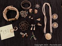 Full lot of assorted vintage costume jewelry including pearl bracelets, necklaces, brooches, earrings