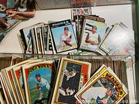 Loose baseball cards spread on table showing Padres, White Sox and Royals cards