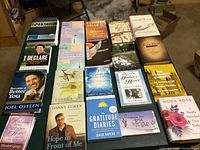 Photo of 20 assorted inspirational and religious books arranged on a table showing covers and titles distinctly.