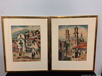 Both framed watercolor paintings by Suarez shown side by side