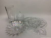 Wide view showing all 7 crystal items including Mikasa vase, covered candy dish, iridescent scalloped dish, and round tray.