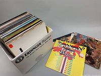 Photo showing box filled with a large collection of vinyl records.