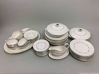 Full lot showing platter, covered vegetable bowls with lids, gravy boat with under-plate, dinner plates, luncheon plates, dessert plates and teacups with saucers.