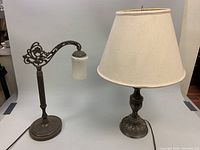 Two metal table lamps shown side by side: a Canarm metal bridge table lamp with frosted glass shade on the left, and a metal lamp with white fabric shade on the right.
