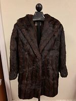 Front full view of the vintage muskrat fur coat showing overall condition and length.