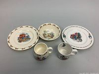 Five porcelain items including Royal Doulton Bunnykins and Wedgwood Peter Rabbit pieces displayed together on a flat surface.