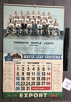 Front page showing Toronto Maple Leafs hockey team 1960-1961 in white uniforms with team and staff members, NHL schedule for October 1961, and brand advertisement.