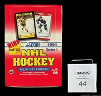 Front view of unopened red box showing promotional Bobby Orr and L.C. Robitaille cards and branding.