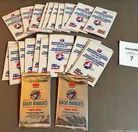 Lot showing twenty 1992 Diet Pepsi Baseball Player Collector Series unopened card packs and two 1993 MacDonald's Toronto Blue Jays Great Moments unopened packs on a white surface with lot number.
