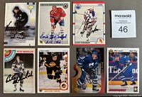 Top view of 8 autographed hockey cards laid out, featuring players Mats Sundin, Doug Gilmour, Trevor Linden, Butch Bouchard, Peter Mahovlich, Vince Damphousse, Glenn Anderson