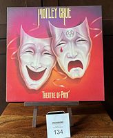 Front cover of Motley Crue Theatre of Pain vinyl LP album showing theatrical masks.