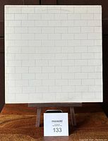 Front view of The Wall album cover showing white brick wall pattern