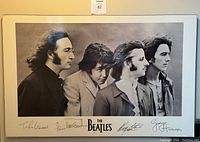 Black and white laminated poster of The Beatles with facsimile autographs below the image, framed and ready to hang.