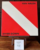 Front cover of Van Halen Diver Down vinyl LP with red and white diagonal stripes and black text.